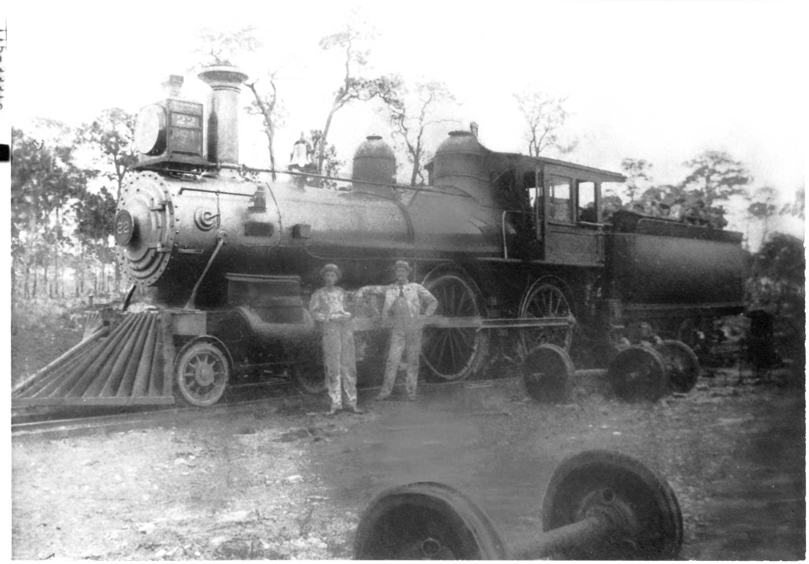 2 people standing in front of a train engine